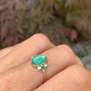 Zambian Emerald Ring with emeralds and diamonds accents.  Presented in  14k yellow gold