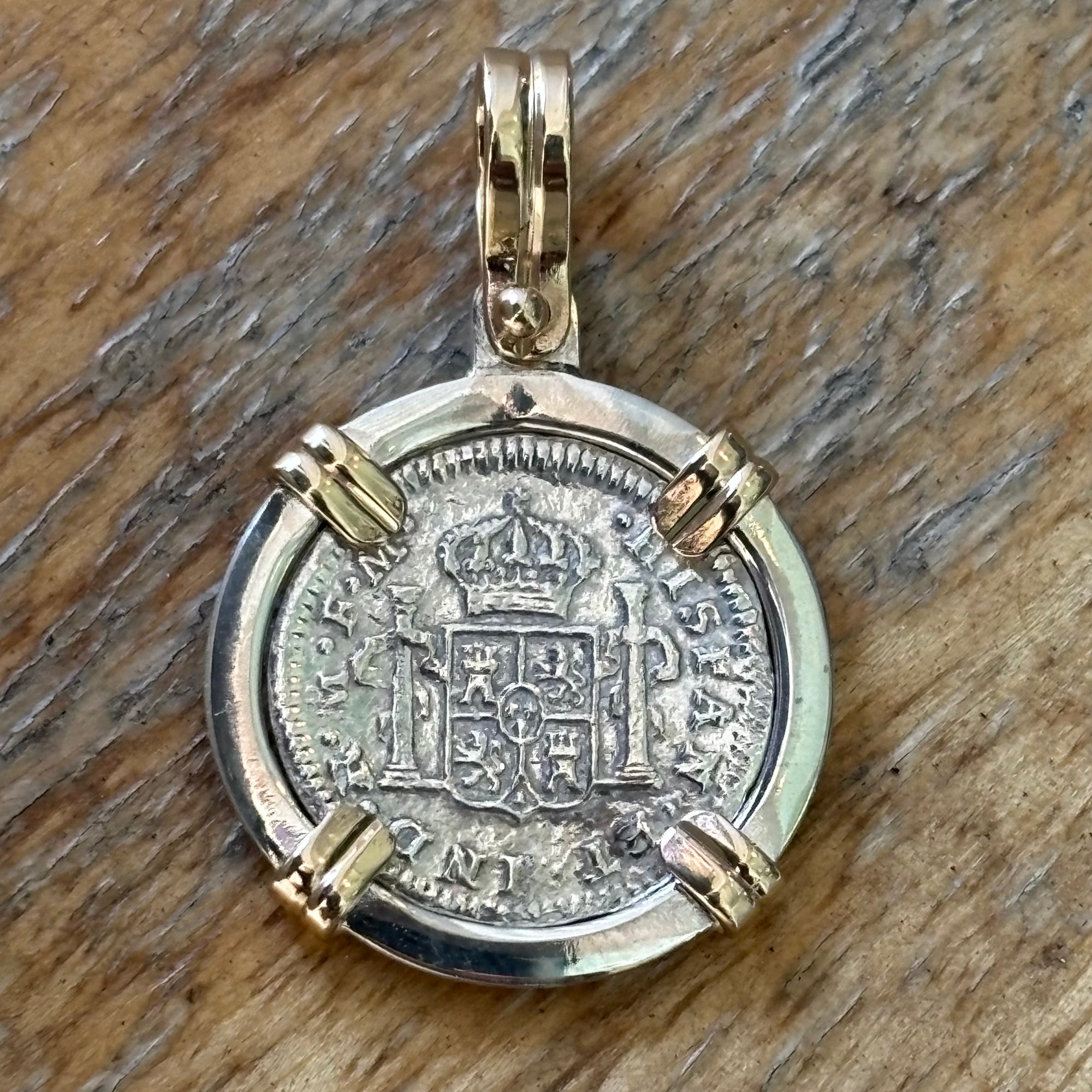 El Cazador Shipwreck - 1/2 Reales - Dated 1777 - Grade Mint - Mounted in a sterling frame with 14K prongs and bale