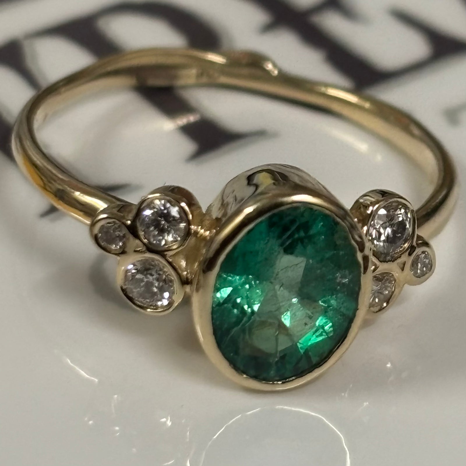 Zambian Emerald in 14K gold ring. Accented with six(6)  Diamonds - Size 7
