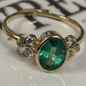 Zambian Emerald in 14K gold ring. Accented with six(6)  Diamonds - Size 7