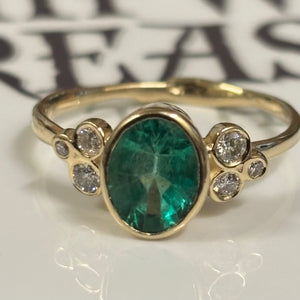 Zambian Emerald in 14K gold ring. Accented with six(6)  Diamonds - Size 7
