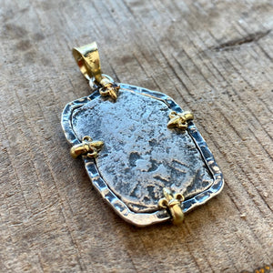 Authentic 1715 Fleet Shipwreck Cob - 4 Reales - Presented in a sterling silver mount and accented with 18 gold prongs and bale.